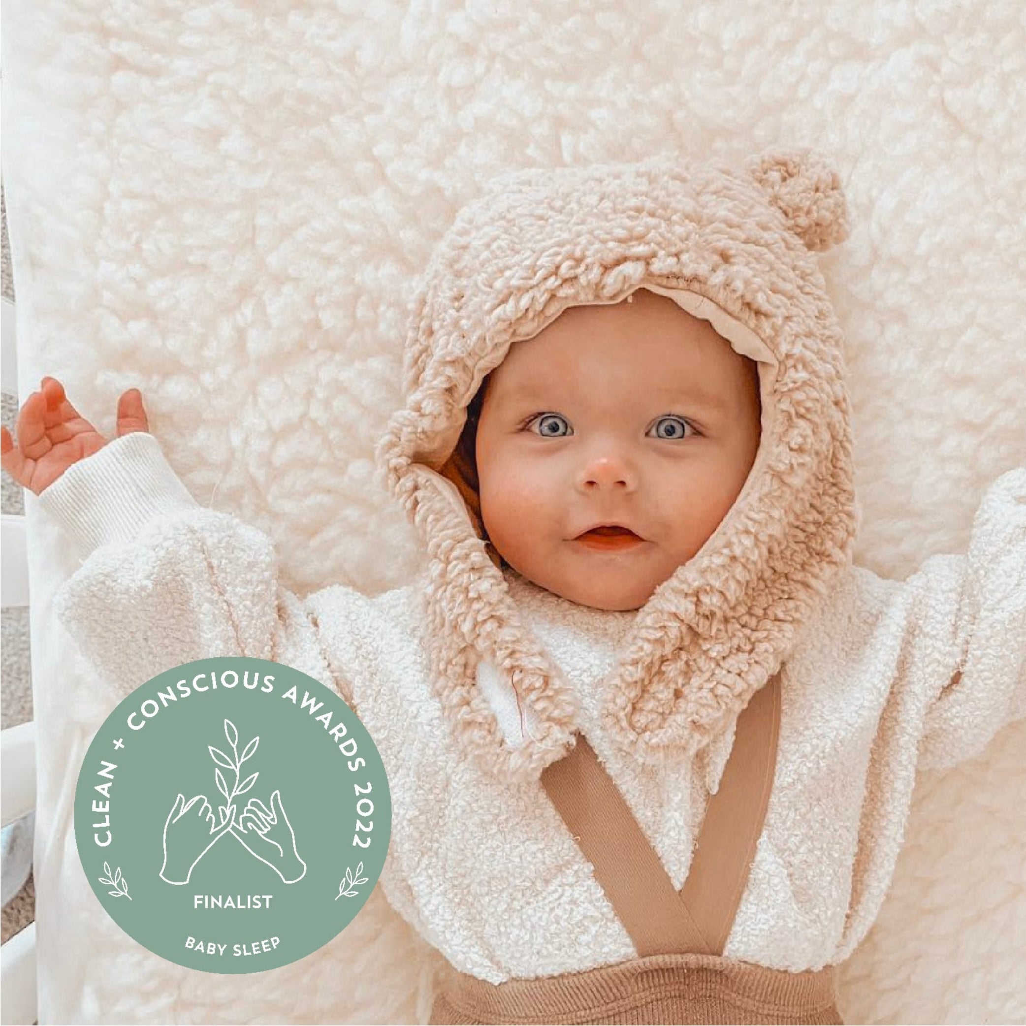 baby laying on wool topper
