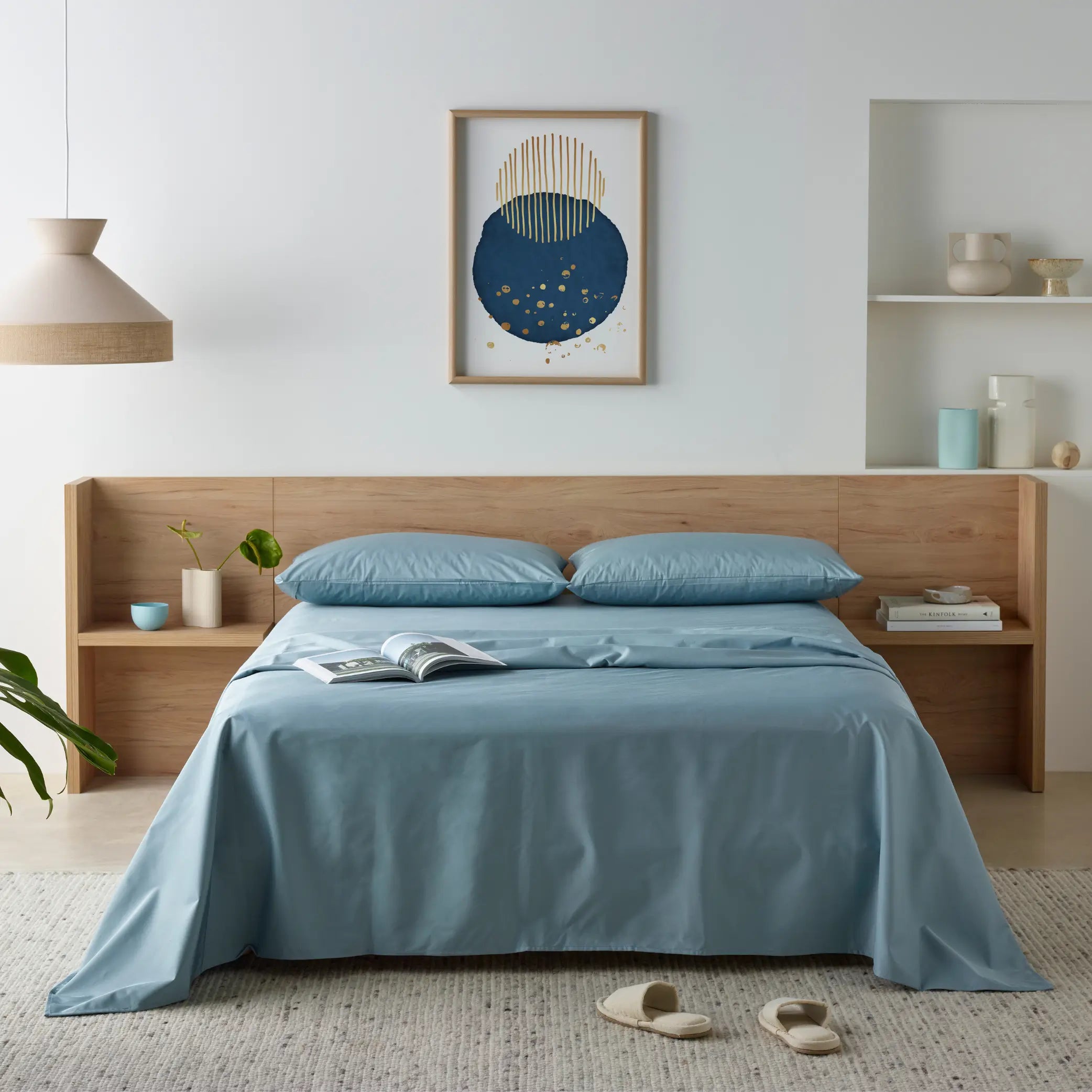 Blue Waterproof Bamboo Fitted Sheet set on a modern wooden bed, featuring a breathable, hypoallergenic, and liquid-resistant design.