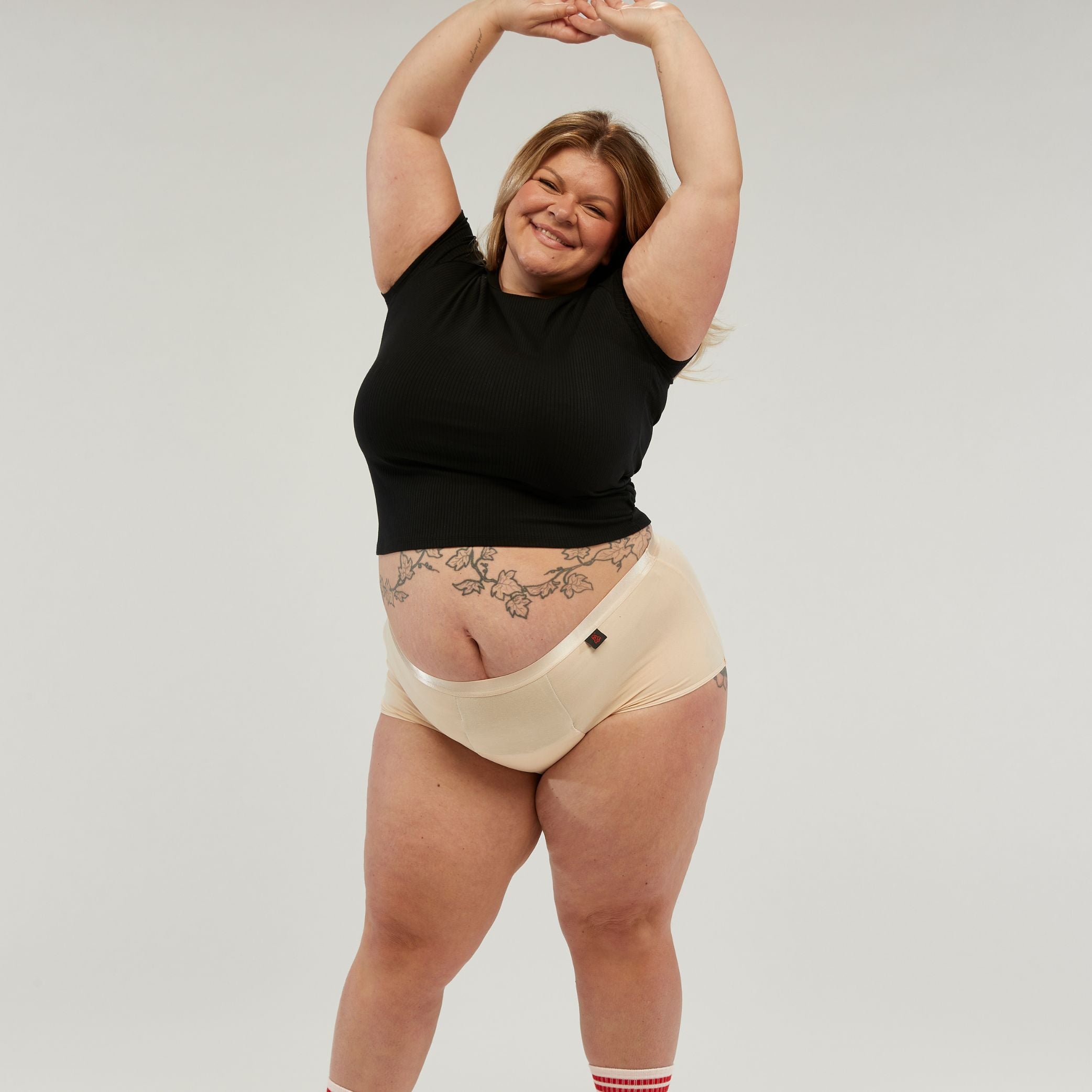 Confident plus-size woman wearing StayDry full brief underwear in skin tone, designed for incontinence protection. Featuring a high-waisted, waterproof, and absorbent design for leak-proof comfort and all-day confidence.